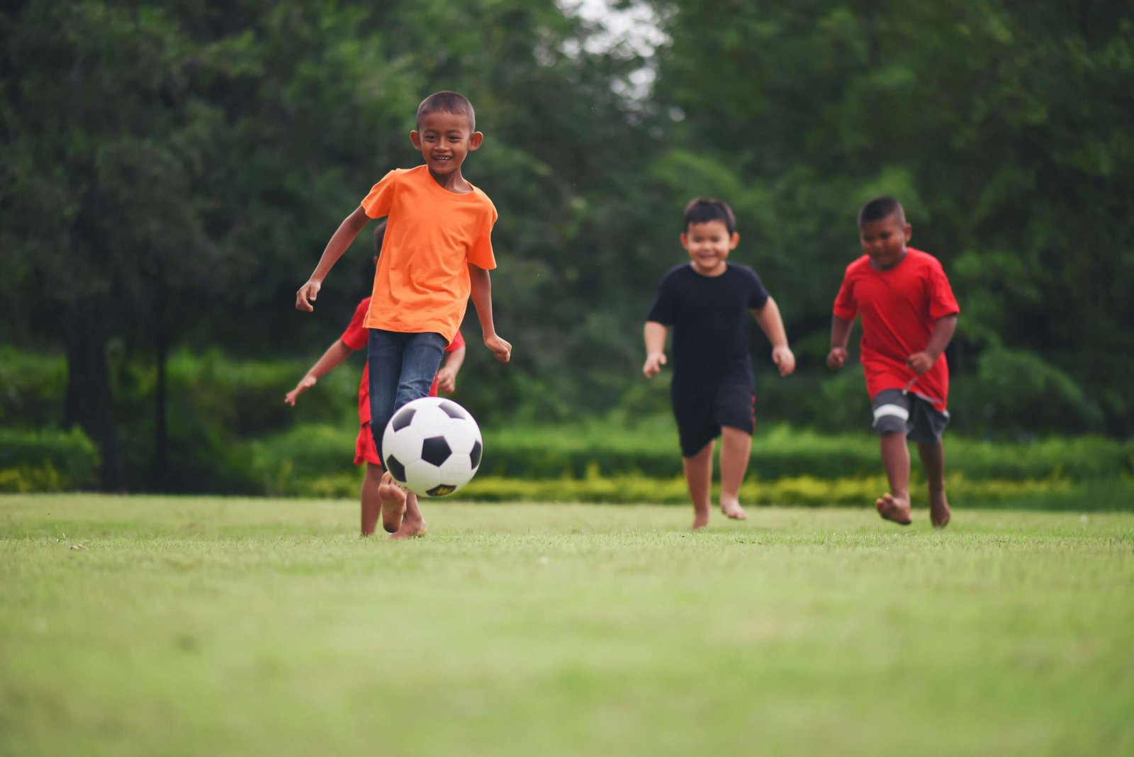 kids playing soccer football scaled.jpg